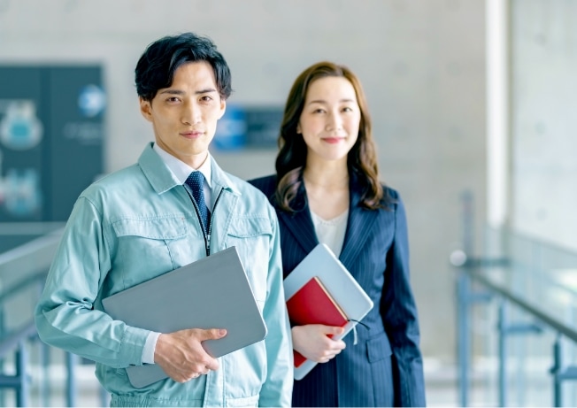 Men in work clothes and women in suits